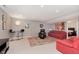 Basement with two red sofas, bar table, and carpeted floors at 1457 Dominion Dr, Zionsville, IN 46077