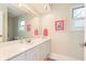 Bright white bathroom with white countertop, cabinets and pink accents at 1457 Dominion Dr, Zionsville, IN 46077