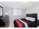 Modern bedroom with grey walls, dark furniture, and black, red and white bed at 1457 Dominion Dr, Zionsville, IN 46077
