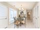 Charming dining area with glass table, elegant chandelier, and natural light at 1457 Dominion Dr, Zionsville, IN 46077