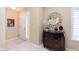 Inviting entryway with decorative mirror, stylish chest, tiled flooring, and a view of the staircase at 1457 Dominion Dr, Zionsville, IN 46077
