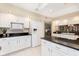 Well-equipped kitchen with white cabinets, black countertops, and modern appliances at 1457 Dominion Dr, Zionsville, IN 46077