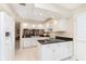 Well-equipped kitchen with white cabinets, black countertops, and modern appliances at 1457 Dominion Dr, Zionsville, IN 46077