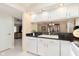 Well-maintained kitchen with white cabinets, a black countertop, and modern appliances at 1457 Dominion Dr, Zionsville, IN 46077