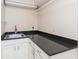 Functional laundry area with dark countertops and ample storage at 1457 Dominion Dr, Zionsville, IN 46077