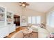 Bright living room features built-in shelves, modern fan, and natural light at 1457 Dominion Dr, Zionsville, IN 46077
