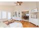 Bright living room features built-in shelving, modern fan, and dining room access at 1457 Dominion Dr, Zionsville, IN 46077