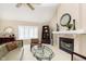 Cozy living room features a fireplace, vaulted ceilings, plantation shutters, and elegant decor at 1457 Dominion Dr, Zionsville, IN 46077