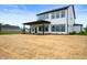 The rear exterior of the home with a covered porch sits on a large lot at 15871 Vitalize Run, Fishers, IN 46040
