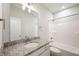 Well-lit bathroom featuring a vanity with granite countertop, and tub/shower combination at 15871 Vitalize Run, Fishers, IN 46040