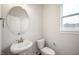 Powder room with a pedestal sink, toilet and natural light from the window at 15871 Vitalize Run, Fishers, IN 46040