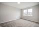 Empty carpeted bedroom with natural light provided by two windows at 15871 Vitalize Run, Fishers, IN 46040