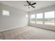 Bright bedroom with a ceiling fan and multiple windows offering scenic views at 15871 Vitalize Run, Fishers, IN 46040