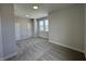 A bedroom with gray walls, carpet, and three windows letting in natural light at 15871 Vitalize Run, Fishers, IN 46040