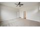 Spacious carpeted bedroom with a ceiling fan and doorways leading to other rooms at 15871 Vitalize Run, Fishers, IN 46040