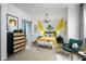 Charming bedroom features unique decor, a stylish bed frame, and a cozy green chair at 15871 Vitalize Run, Fishers, IN 46040
