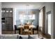 Elegant dining room with modern lighting, stylish furnishings, and hardwood floors at 15871 Vitalize Run, Fishers, IN 46040