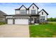 Beautiful two-story home with a modern farmhouse design, two-car garage, and well-manicured lawn at 15871 Vitalize Run, Fishers, IN 46040