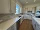 Well-equipped kitchen with white cabinets, modern appliances, and stylish backsplash at 15871 Vitalize Run, Fishers, IN 46040