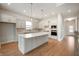 Spacious kitchen with a large island, modern appliances, and light gray cabinetry at 15871 Vitalize Run, Fishers, IN 46040