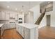 Bright, spacious kitchen featuring stainless appliances, a center island, and a view of the stairs at 15871 Vitalize Run, Fishers, IN 46040