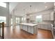 Open-concept kitchen with a large island, stainless steel appliances, and modern lighting at 15871 Vitalize Run, Fishers, IN 46040