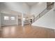 Open-concept living room and kitchen area with high ceilings, hardwood floors, and lots of natural light at 15871 Vitalize Run, Fishers, IN 46040