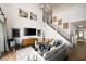 Spacious living room with high ceilings, a cozy seating area, and stylish decor at 15871 Vitalize Run, Fishers, IN 46040