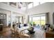 Open-concept living room with high ceilings, lots of natural light, and stylish decor at 15871 Vitalize Run, Fishers, IN 46040