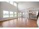 Bright and spacious living room features hardwood floors and large windows, with an eat-in kitchen on the side at 15871 Vitalize Run, Fishers, IN 46040