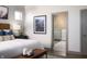 Cozy bedroom showcasing an ensuite bathroom with a view, and a comfortable bed at 15871 Vitalize Run, Fishers, IN 46040
