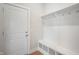Bright mudroom features a door, cubbies, bench, coat hooks, and wood flooring at 15871 Vitalize Run, Fishers, IN 46040