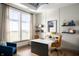 Bright home office featuring large windows, a modern desk, and elegant decor at 15871 Vitalize Run, Fishers, IN 46040