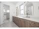 Elegant bathroom featuring double vanity, quartz countertops, and stylish gold fixtures with access to walk-in closet at 17364 Pinellas Ave, Westfield, IN 46074