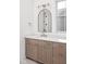 Bathroom featuring a vanity with wood cabinets, white countertop, modern mirror, and natural lighting at 17364 Pinellas Ave, Westfield, IN 46074