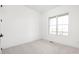 A simple bedroom with plush carpet, a window with natural light and white walls offering a comfortable retreat at 17364 Pinellas Ave, Westfield, IN 46074