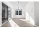 Bright dining area with hardwood floors, sliding glass doors, and modern lighting fixture at 17364 Pinellas Ave, Westfield, IN 46074