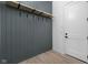 Contemporary entryway featuring vertical wood paneling with hooks and wood-look flooring for a welcoming space at 17364 Pinellas Ave, Westfield, IN 46074