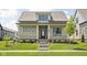 Charming one-story home featuring a welcoming front porch, manicured lawn, and professional landscaping at 17364 Pinellas Ave, Westfield, IN 46074