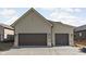 Attached three-car garage with modern exterior finishes and concrete driveway at 17364 Pinellas Ave, Westfield, IN 46074