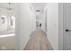 Inviting hallway with modern wood-look flooring and neutral color scheme leading into the kitchen at 17364 Pinellas Ave, Westfield, IN 46074