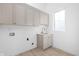 Functional laundry room featuring stylish cabinets, a sink, and ample space for laundry tasks at 17364 Pinellas Ave, Westfield, IN 46074