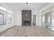 Bright living room featuring a sleek fireplace, modern lighting, and sliding glass doors at 17364 Pinellas Ave, Westfield, IN 46074