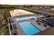 Aerial view of a community pool with ample seating, cabanas and a pond view at 17364 Pinellas Ave, Westfield, IN 46074