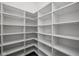 Walk-in closet with white shelving and hardwood flooring at 17364 Pinellas Ave, Westfield, IN 46074