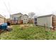The backyard features a firepit, green grass, shed, and the back of the home at 1820 E Maryland St, Indianapolis, IN 46201