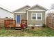 Backyard view with a blue door, small wood porch, and green vinyl siding at 1820 E Maryland St, Indianapolis, IN 46201