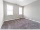 Empty bedroom featuring neutral paint, carpet floors, base molding and natural light at 1820 E Maryland St, Indianapolis, IN 46201