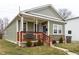 Inviting home with a covered porch, a blue front door, and charming curb appeal at 1820 E Maryland St, Indianapolis, IN 46201