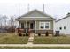 Charming home featuring stylish green siding, stone accents, and a cozy front porch at 1820 E Maryland St, Indianapolis, IN 46201